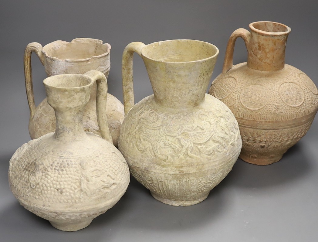 A selection of four Islamic terracotta jugs, Middle Eastern, possibly 12th century AD, The tallest 25 cm